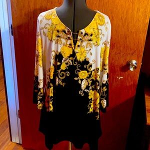 Yellow/gold print on black tunic style top.